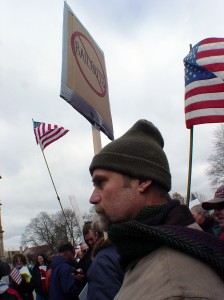 Protester looks on during a speech at the event
